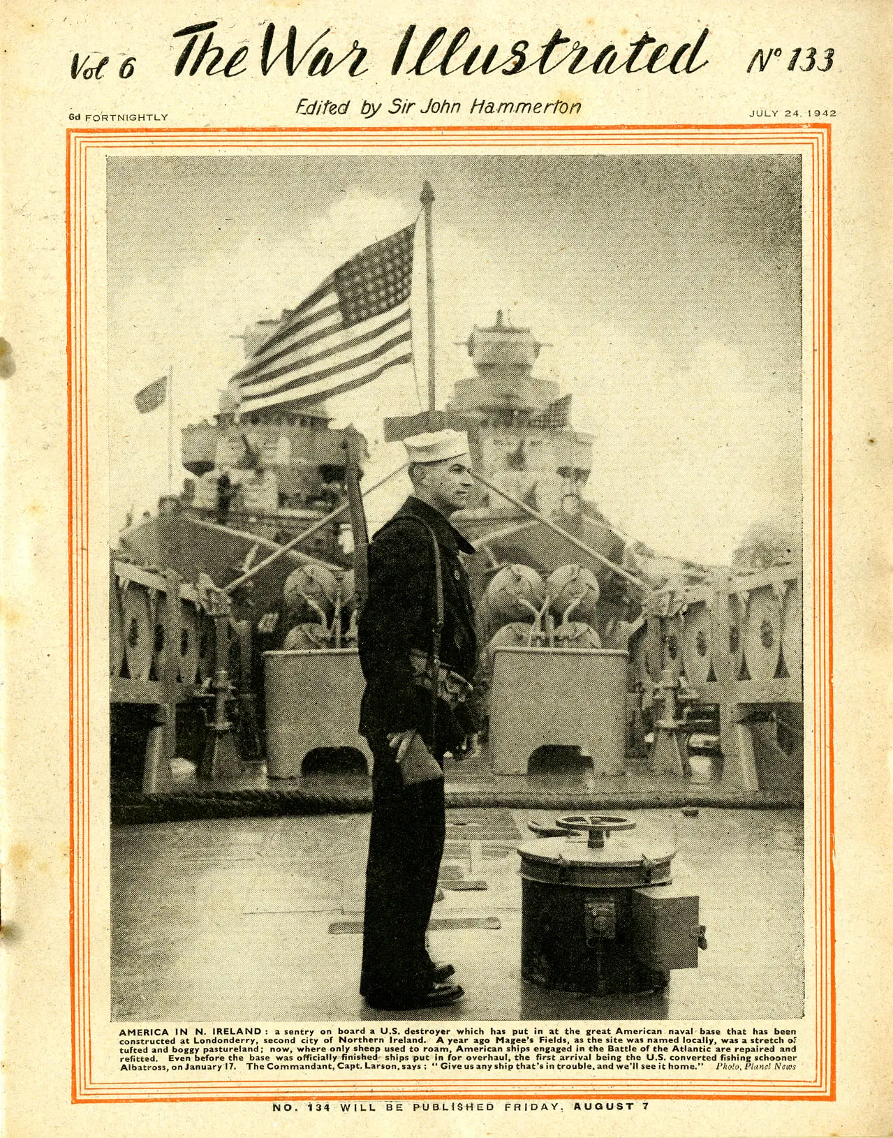 The front page of the British magazine "THE WAR ILLUSTRATED" published, July 24, 1942. The page is taken up by a photograph of an American sailor standing on the deck of a destroyer with a rifle over his shoulder, an American flag waving behind him, and two larger American ships looming close behind.